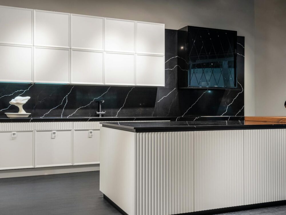 Contemporary kitchen interior design with empty white and black furniture in modern stylish apartment