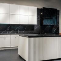 Contemporary kitchen interior design with empty white and black furniture in modern stylish apartment