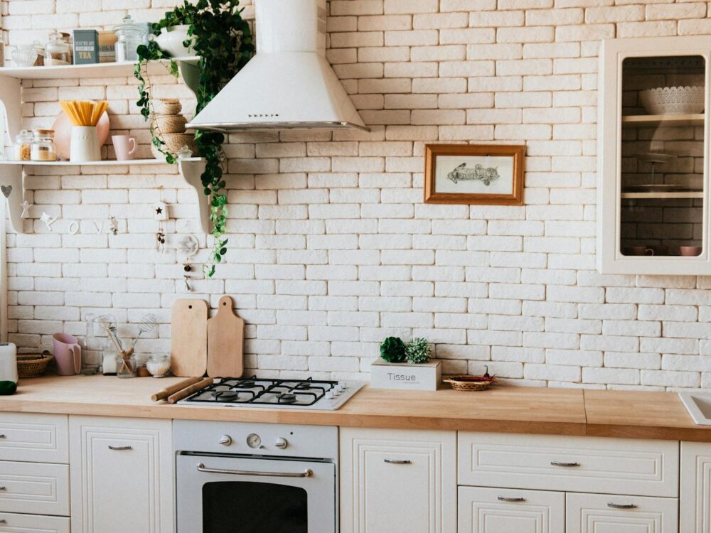 Stylish kitchen interior with modern appliances, wooden counters, and greenery accents.